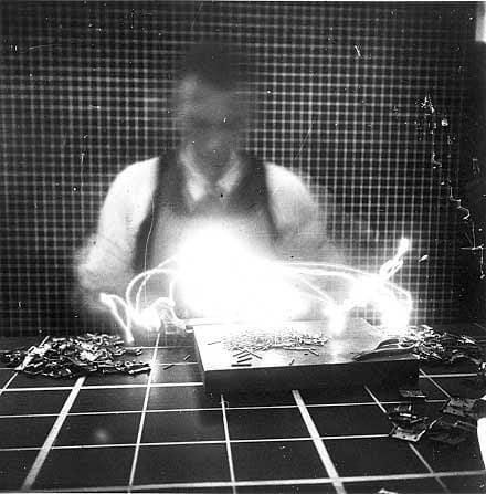 Historic black-and-white motion study photograph showing glowing light trails created during an early long exposure experiment