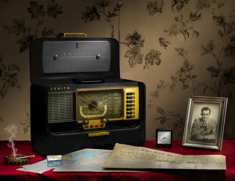 Vintage Zenith radio with framed photograph and decorative items on a red tablecloth.