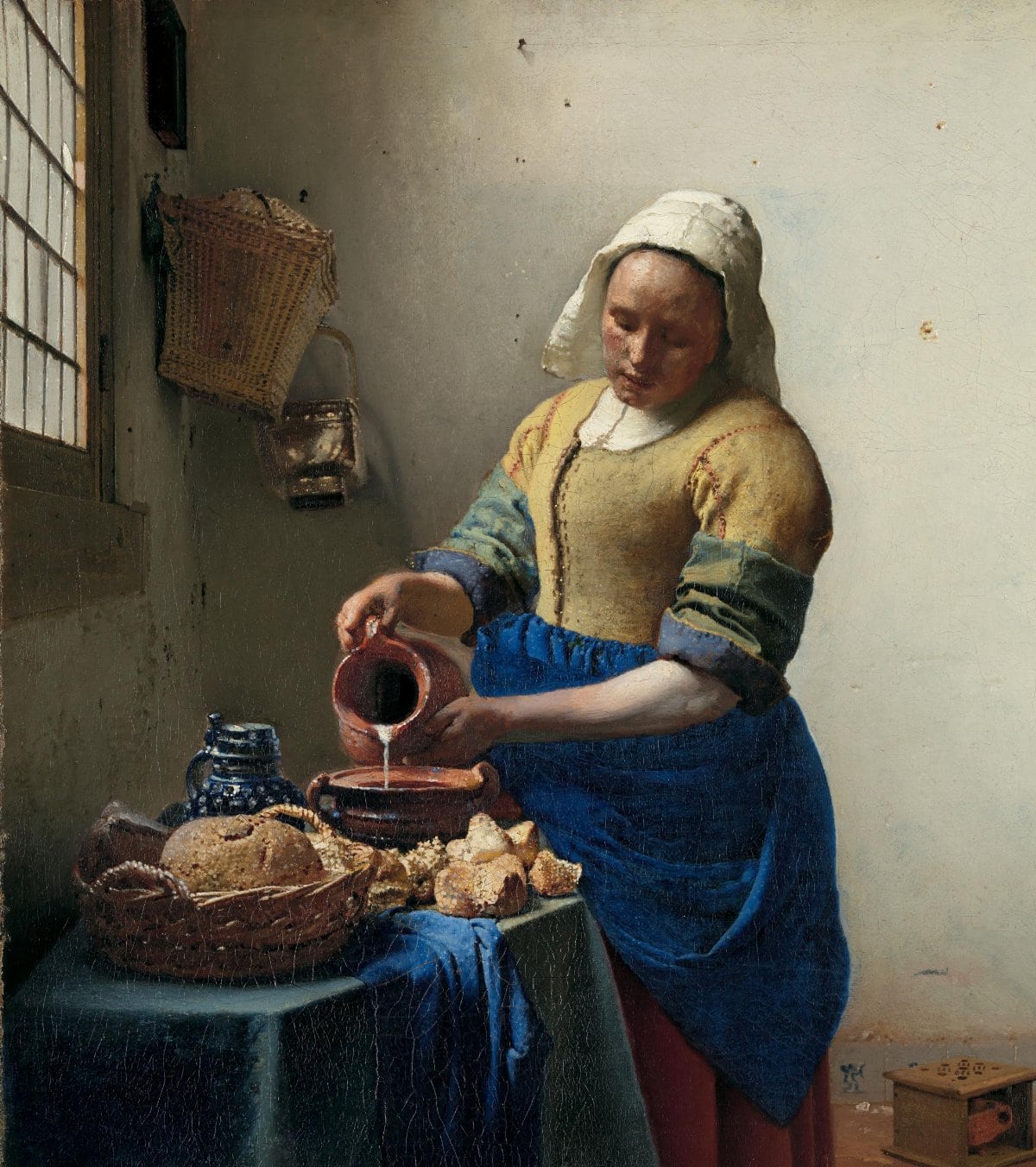 Vermeer's The Milkmaid, lit by quiet daylight through a leaded window