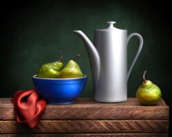 A still life composition featuring green pears in a blue bowl, a white teapot, and a single pear on a wooden surface with a dark background. Still life of pears, teapot, bowl, and red cloth by Bobby Izquierdo