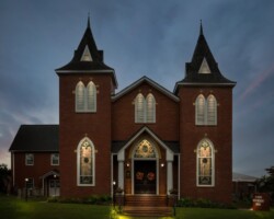 This is a photograph of the United First Methodist Church in downtown Pittsboro, NC. It was taken on Oct. 10, 2021, and converted to nighttime using post-processing. The photographer removed the usually visible powerlines and other distracting elements. Pittsboro nightscape fine art photograph by Bobby Izquierdo, limited edition