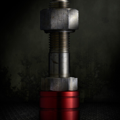 Still Life Bolt and Nut on Red Bushing Still Life Bolt and Nut on Red Bushing